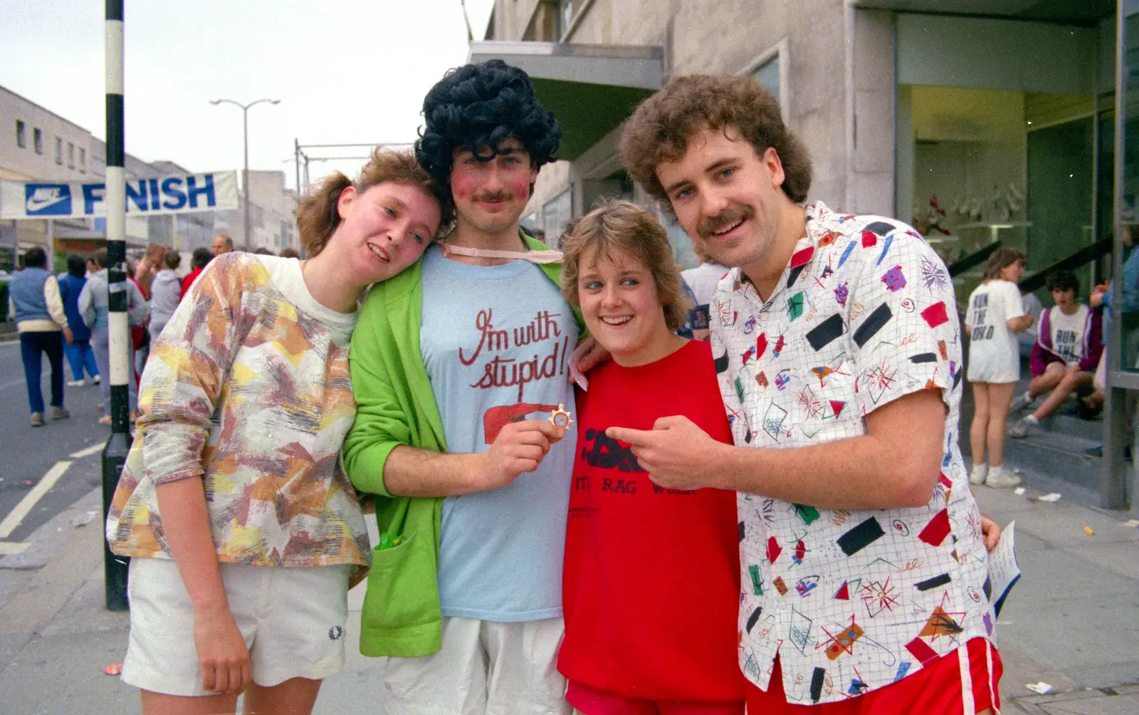 Alison, Mark, ? and Sam show off their badge, from Uni: Sport Aid - Run The World, Plymouth, Devon - 25th May 1986