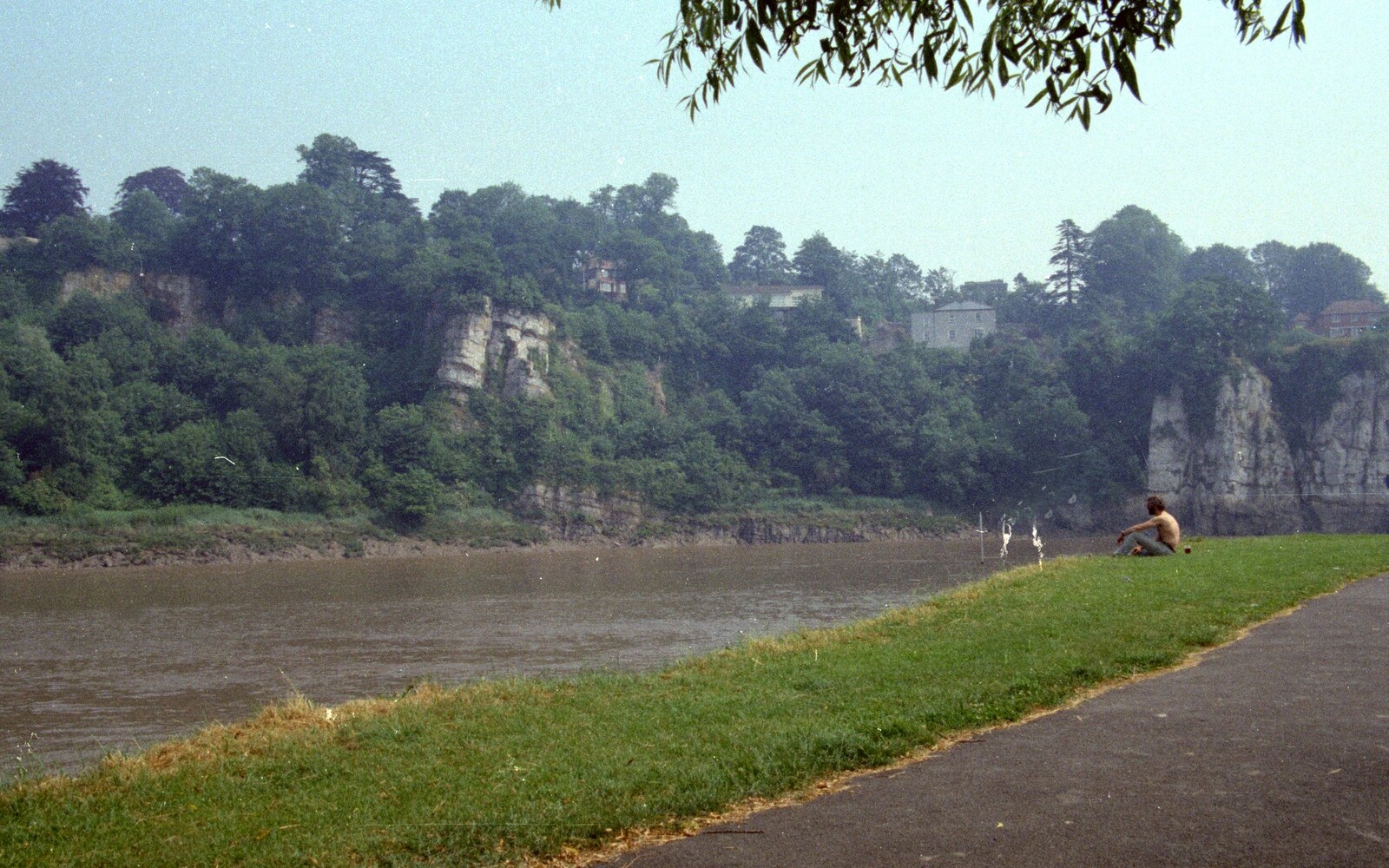 Some dude sits on the bank by the river from A Trip to Chepstow, Monmouthshire, Wales - 5th July 1986