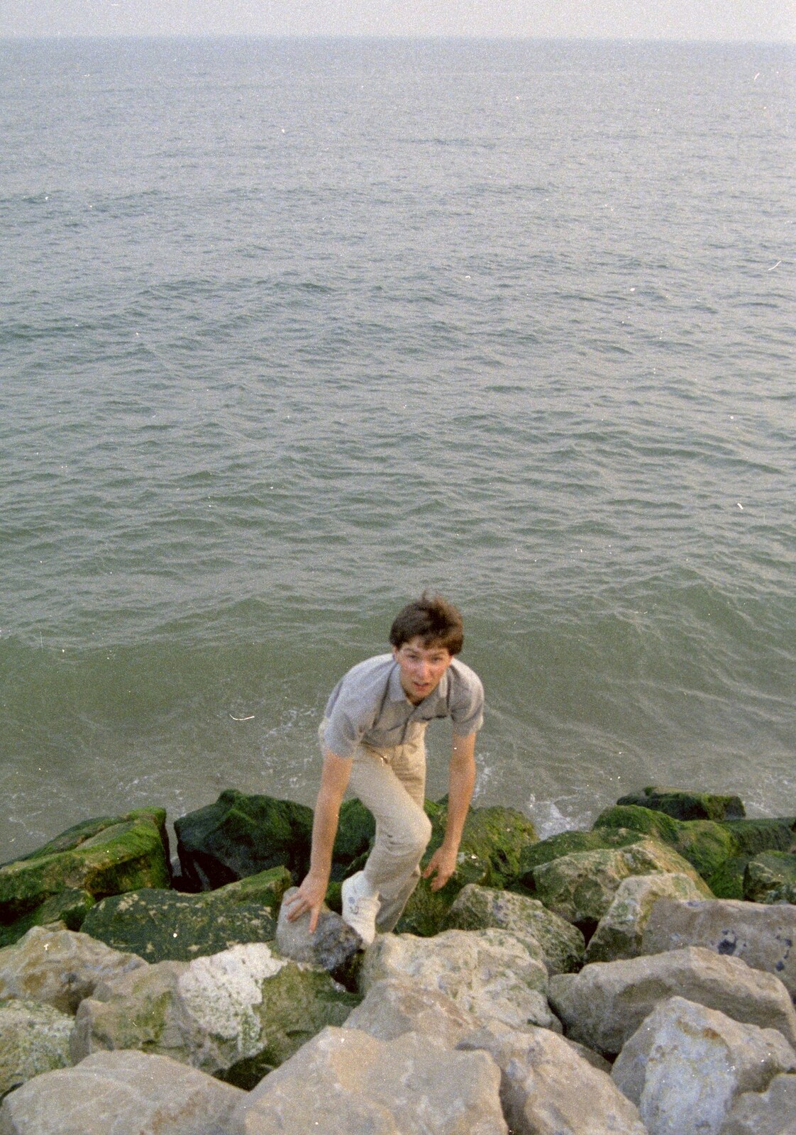 Sean clambers up the rocks from On the Beach Again and the CB Gang at the Pub, Barton on Sea and Hordle, Hampshire - 12th July 1986