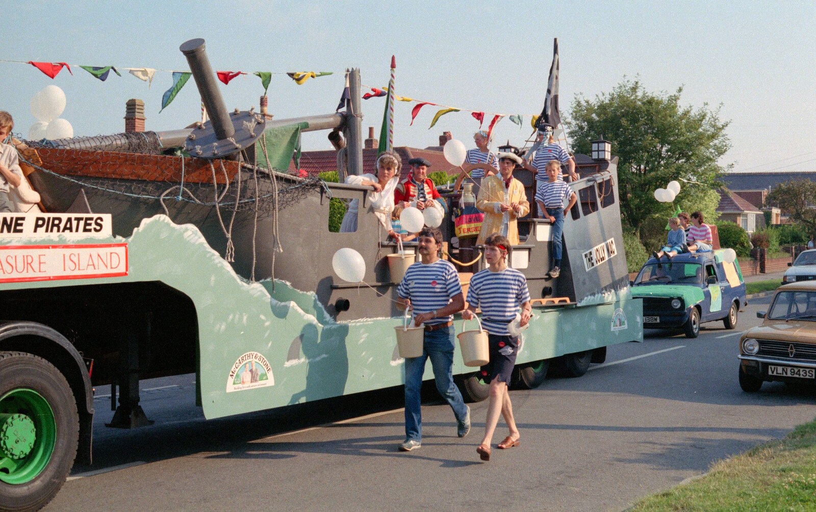 Sean walks along by the McCarthy and Stone float from Sean and the New Milton Carnival, Hampshire - 1st August 1986