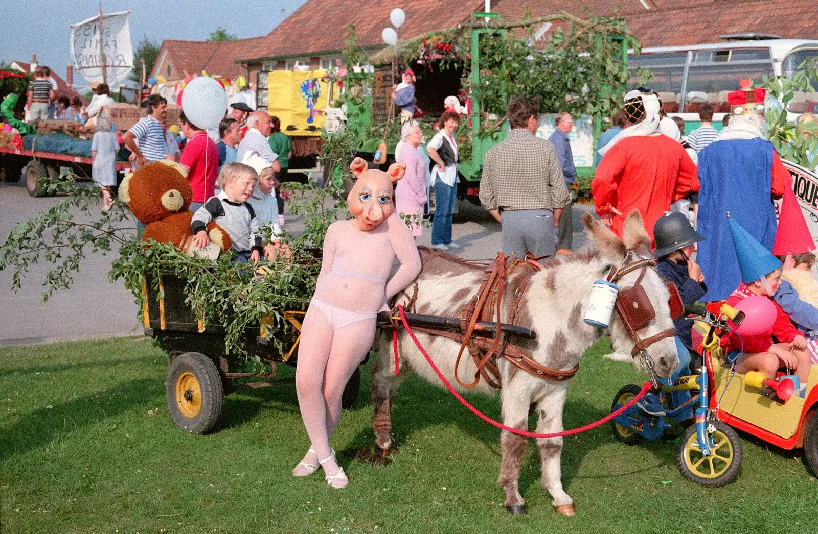 A girl in a pig mask with a small donkey, from Sean and the New Milton Carnival, Hampshire - 1st August 1986