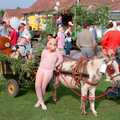A girl in a pig mask with a small donkey, Sean and the New Milton Carnival, Hampshire - 1st August 1986