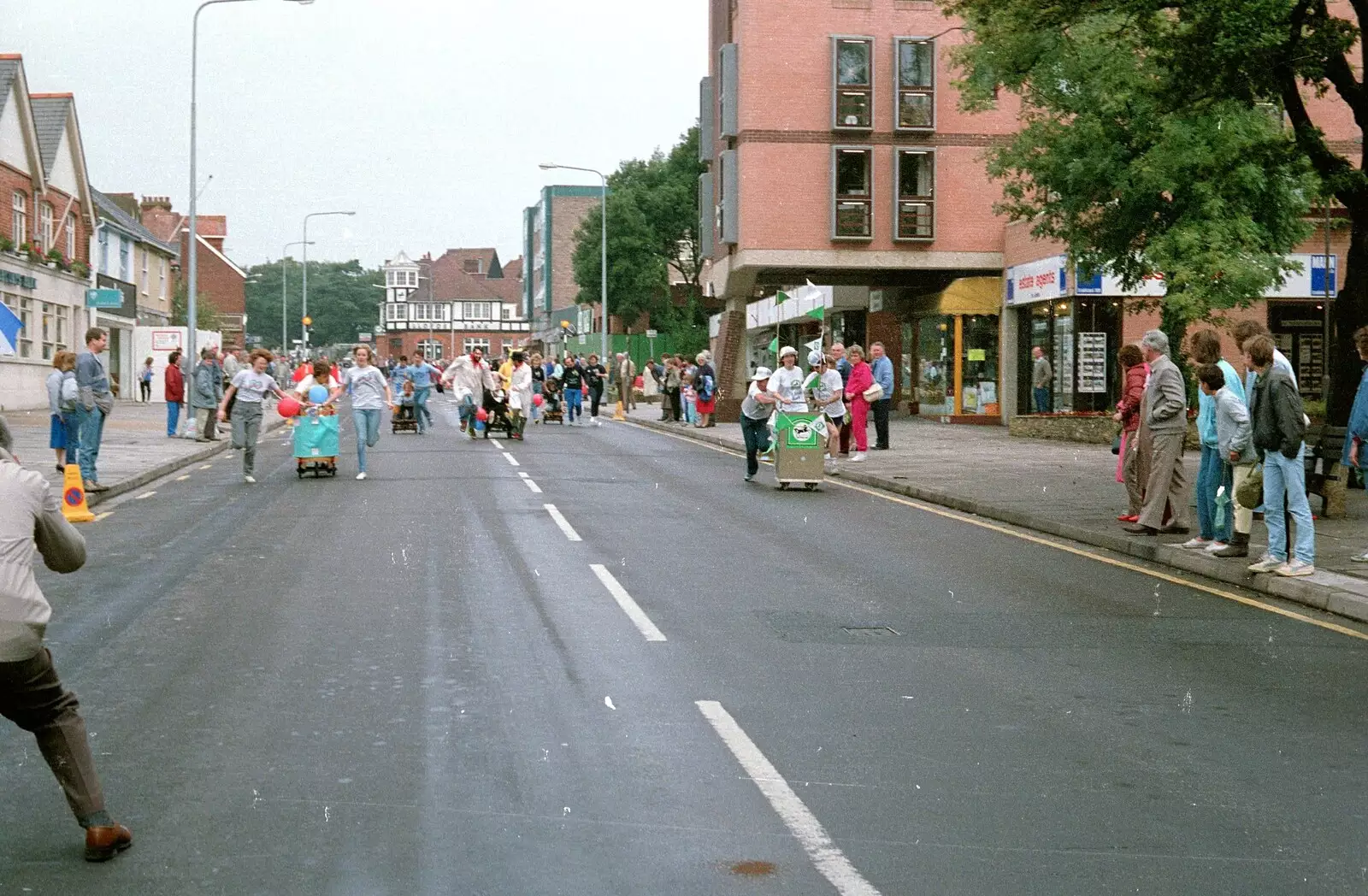 The Fun Run goes past Barclays Bank, from The New Forest Marathon, New Milton, Hampshire - 14th September 1986