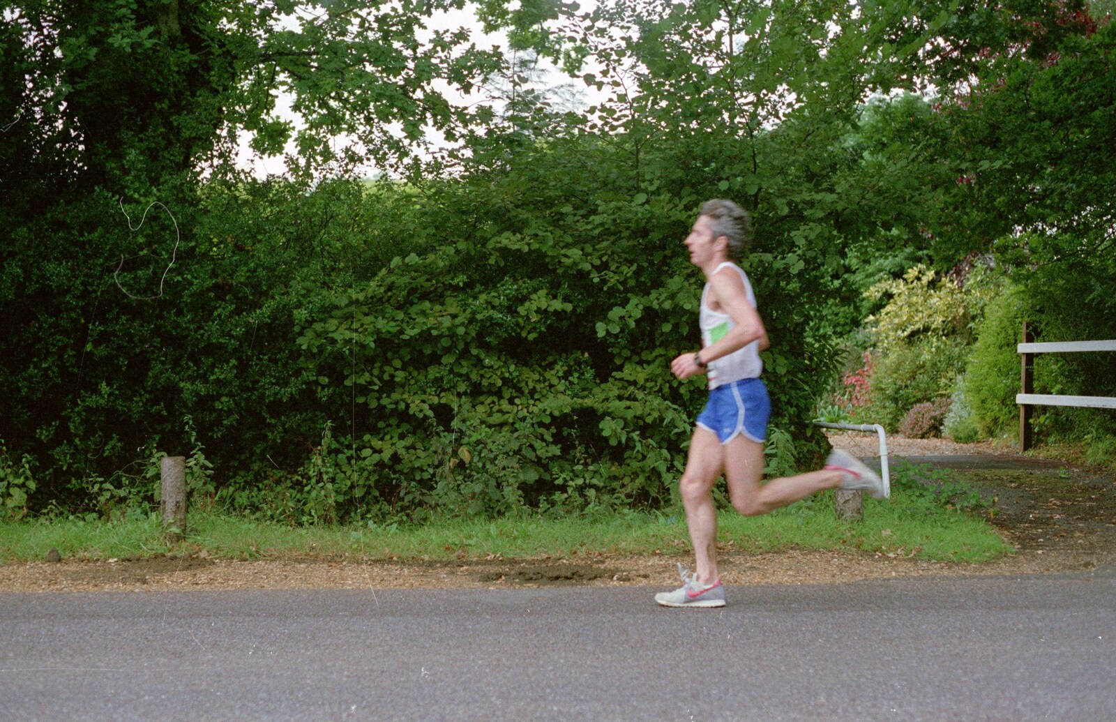 Another runner legs it down Sway Road from The New Forest Marathon, New Milton, Hampshire - 14th September 1986