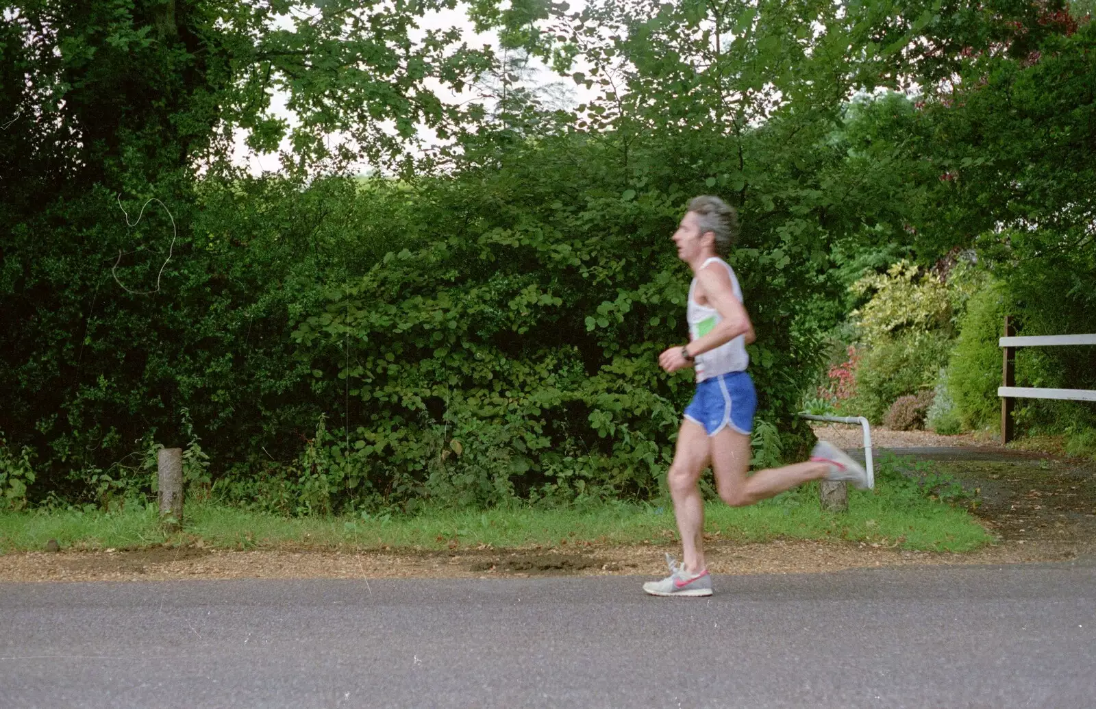 Another runner legs it down Sway Road, from The New Forest Marathon, New Milton, Hampshire - 14th September 1986