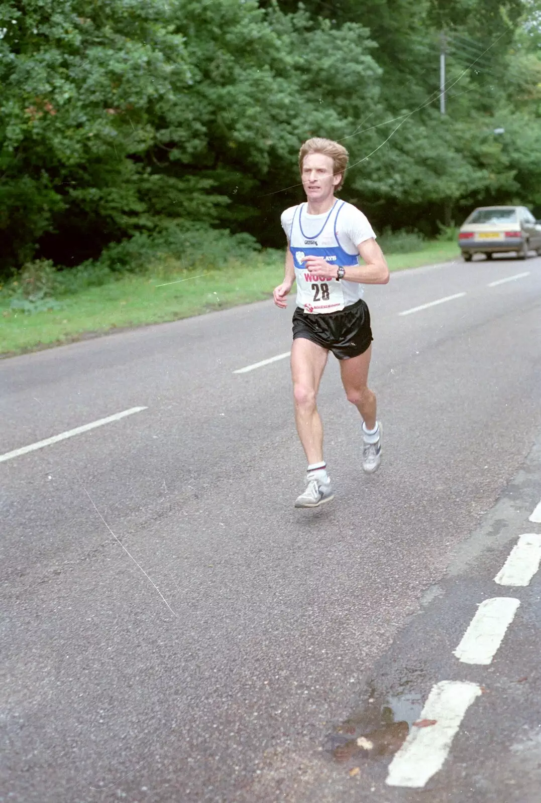 A marathon runner legs it through Brockenhurst, from The New Forest Marathon, New Milton, Hampshire - 14th September 1986