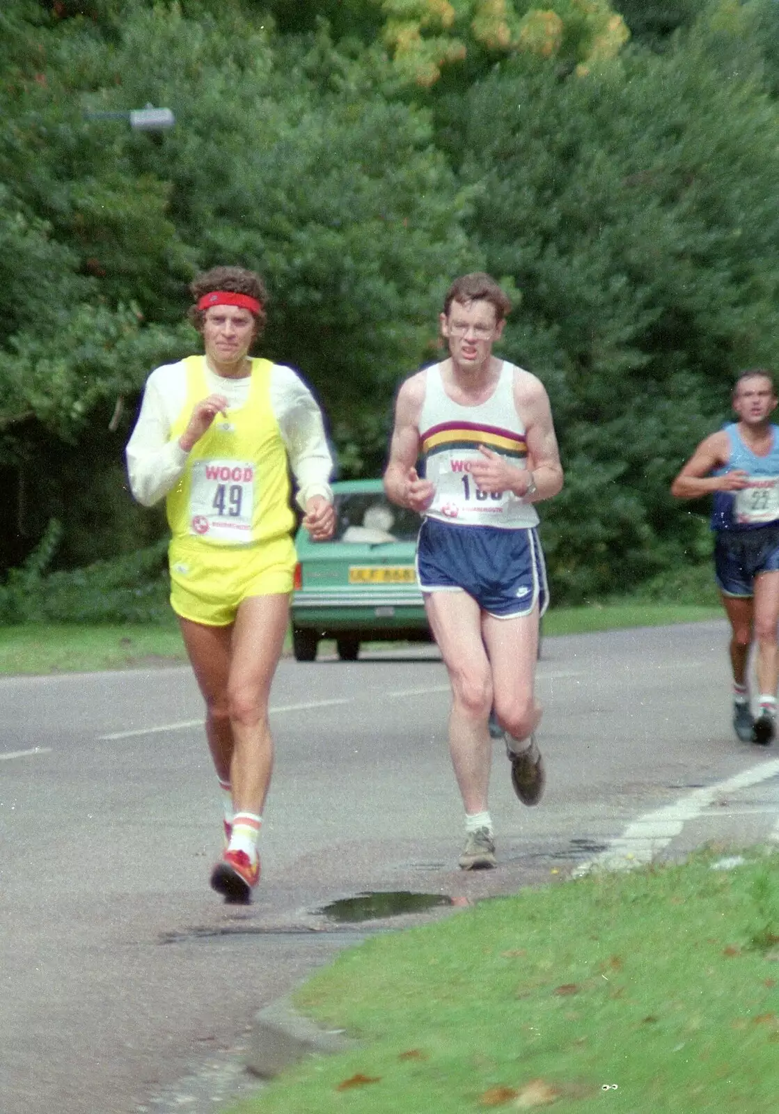 More runners pass through Brockenhurst, from The New Forest Marathon, New Milton, Hampshire - 14th September 1986