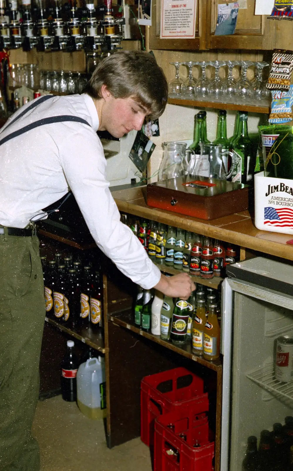 A bottle of Satique is selected by the barman, from Uni: The Plymouth Polytechnic Satique Project, Salcombe and Plymouth - 10th November 1986