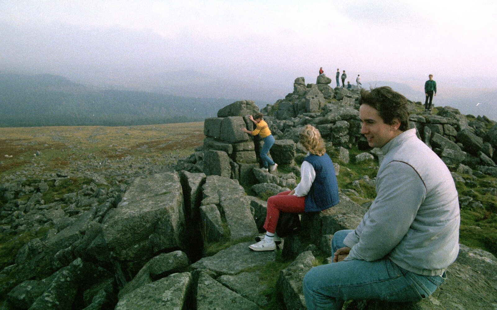 Riki sits on a tor and admires the view from A Trip to Trotsky's Mount, Dartmoor, Devon - 20th March 1987