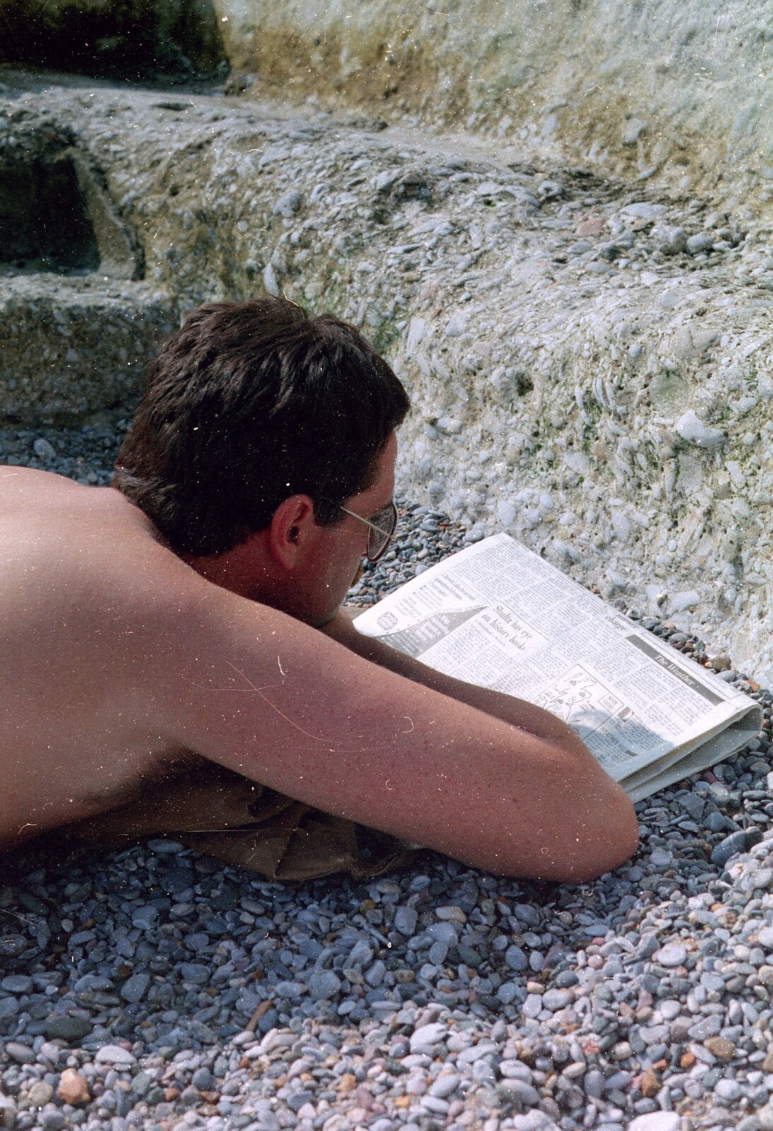 Ed reads the newspaper on the beach from Uni: A Neath Road Summer, St. Jude's, Plymouth - 18th August 1987