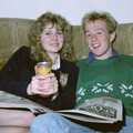 Emma and Martin read the paper, Soman-Wherry Footie Action, Norfolk - 25th February 1988