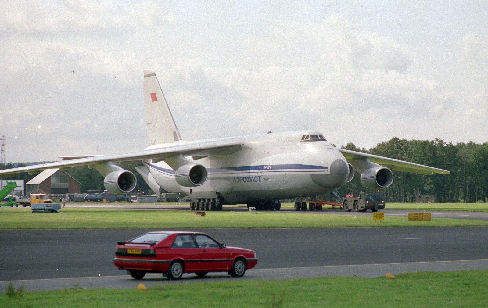 An Audi Quattro roars past the huge Antonov from Visiting Sean and Farnborough Airshow, Hampshire - 15th July 1988