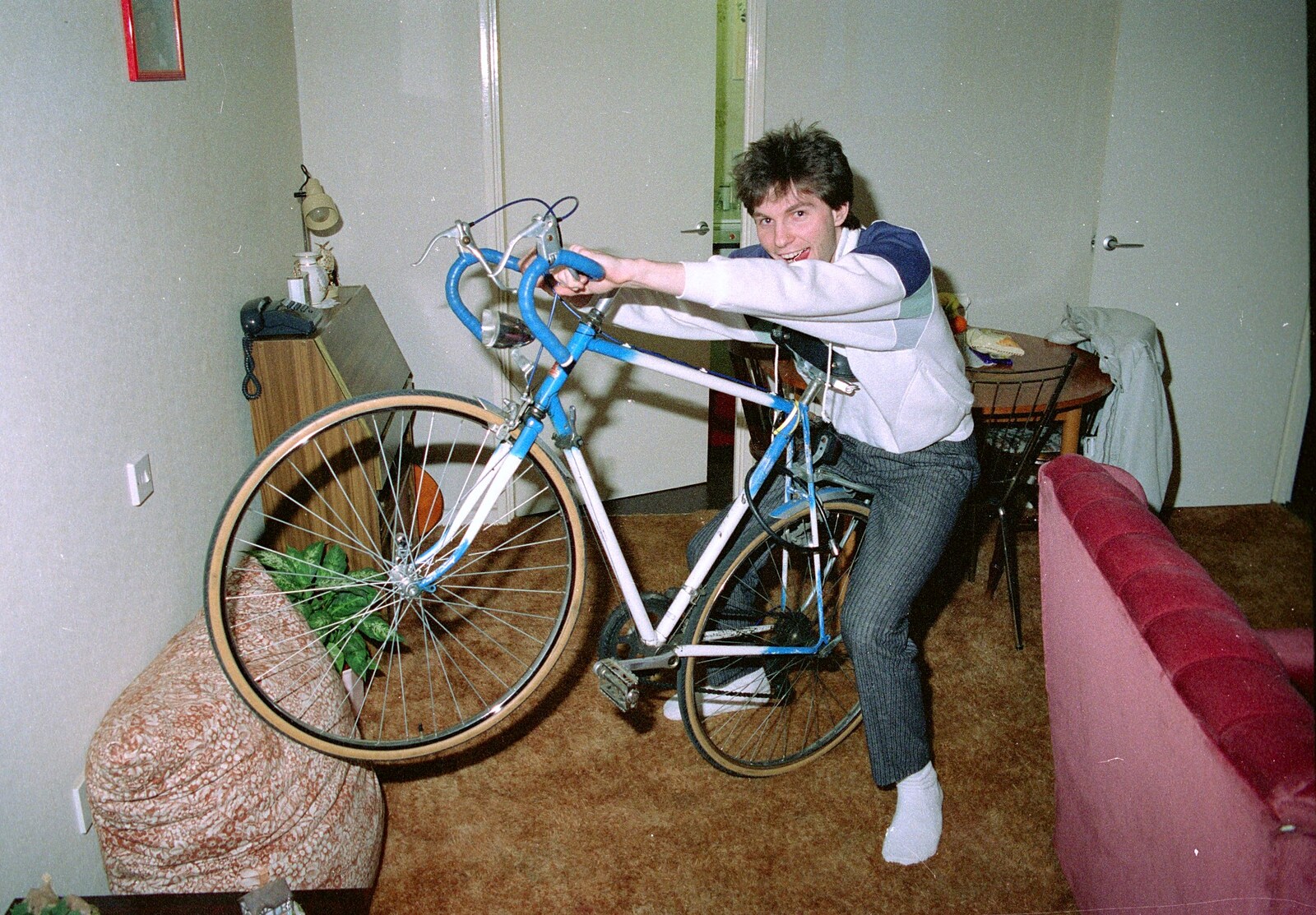 Sean rides Nosher's bike in his lounge from Leaving Sewell's Cottages: from Red House to New Milton and Farnborough - 22nd September 1988