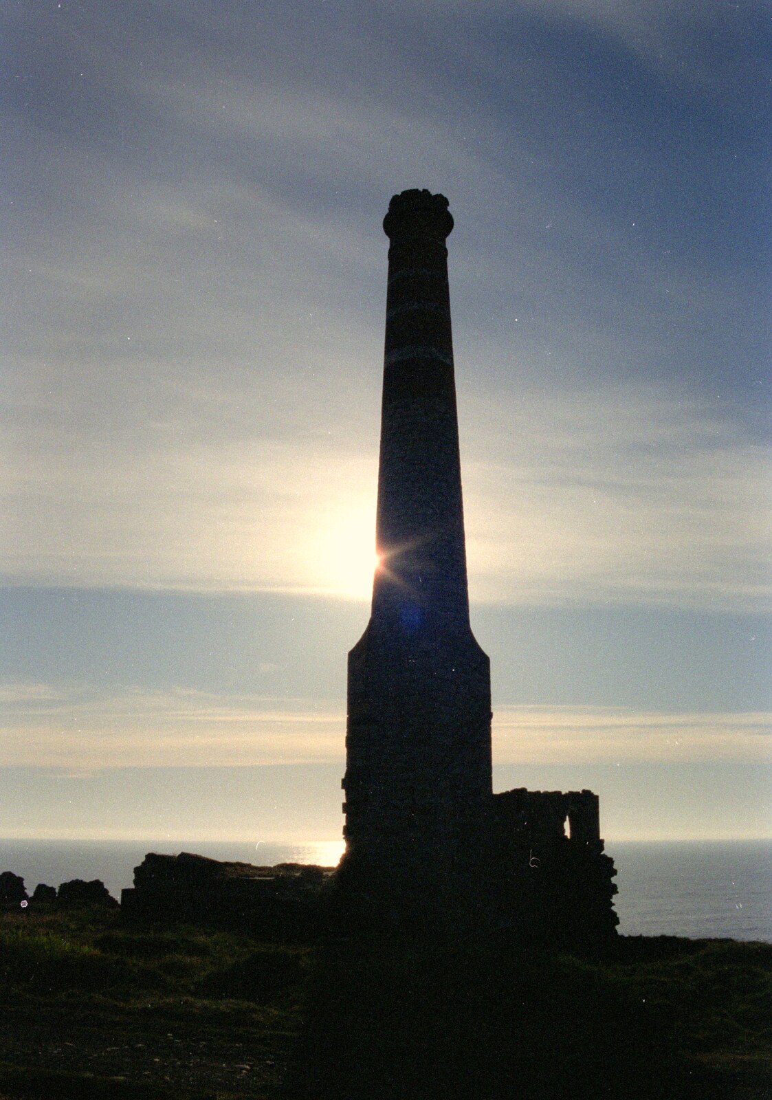 A derelict tin mine chimney, backed by the sun from Uni: An End-of-it-all Trip to Land's End, Cornwall - 13th June 1989
