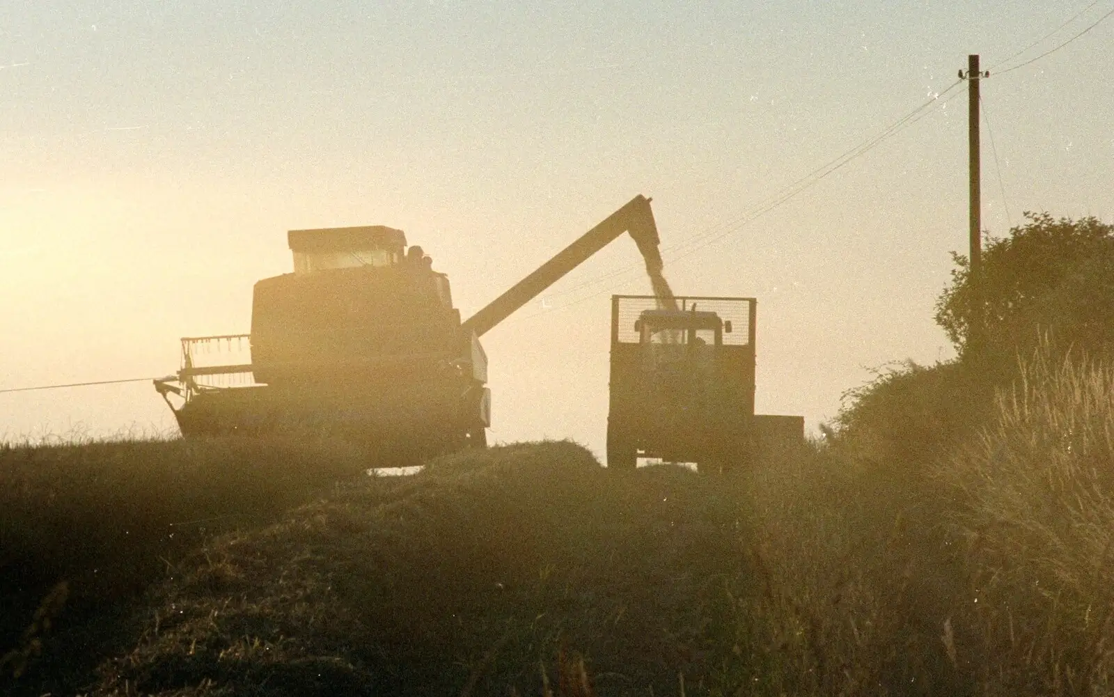 A Combine harvester rumbles around, from Summer Days on Pitt Farm, Harbertonford, Devon - 17th July 1989