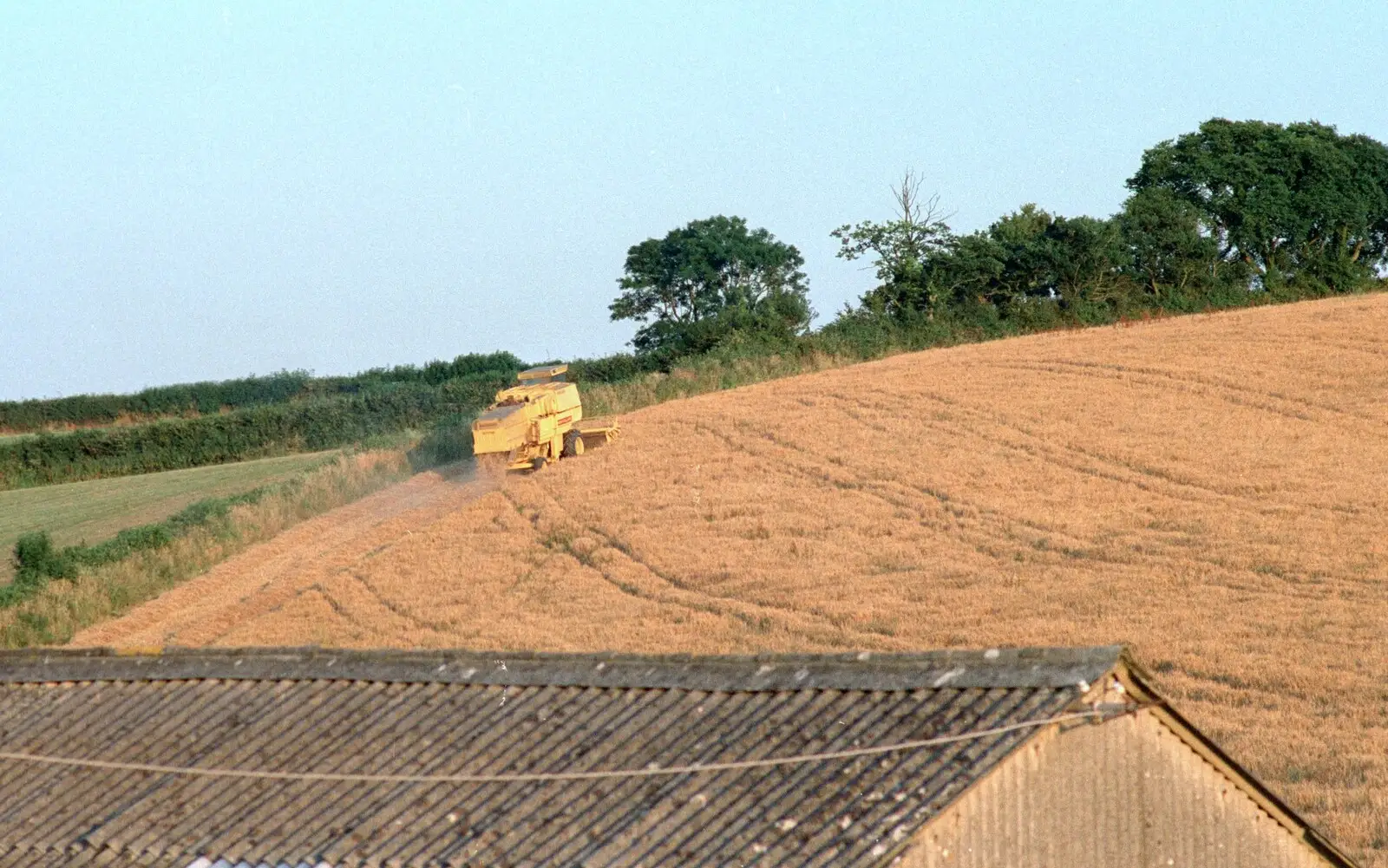 The combine trundles around a field edge, from Summer Days on Pitt Farm, Harbertonford, Devon - 17th July 1989