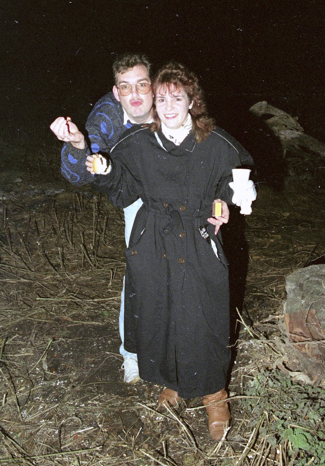 Steve and Sam hold something up from A Stuston Bonfire Night, Suffolk - 5th November 1989