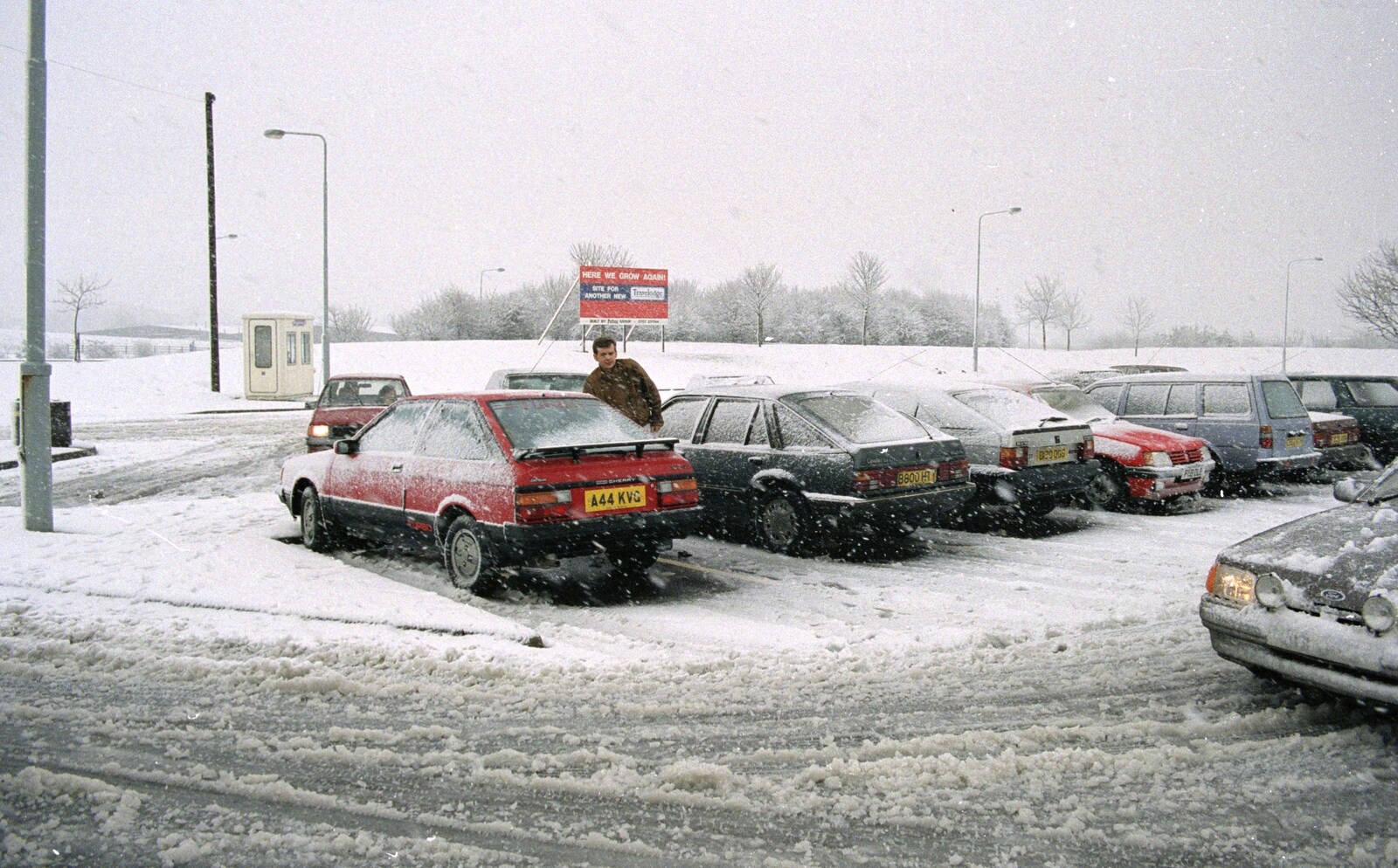 A Trip to Plymouth and Bristol, Avon and Devon - 18th February 1990: Karl locks up his car at Membury services. The sign in the background announces the as-yet unbuilt Travelodge