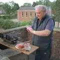 Kenny pats some burgers together on his balcony, An "Above The Laundrette" Barbeque, Diss, Norfolk - 28th May 1990