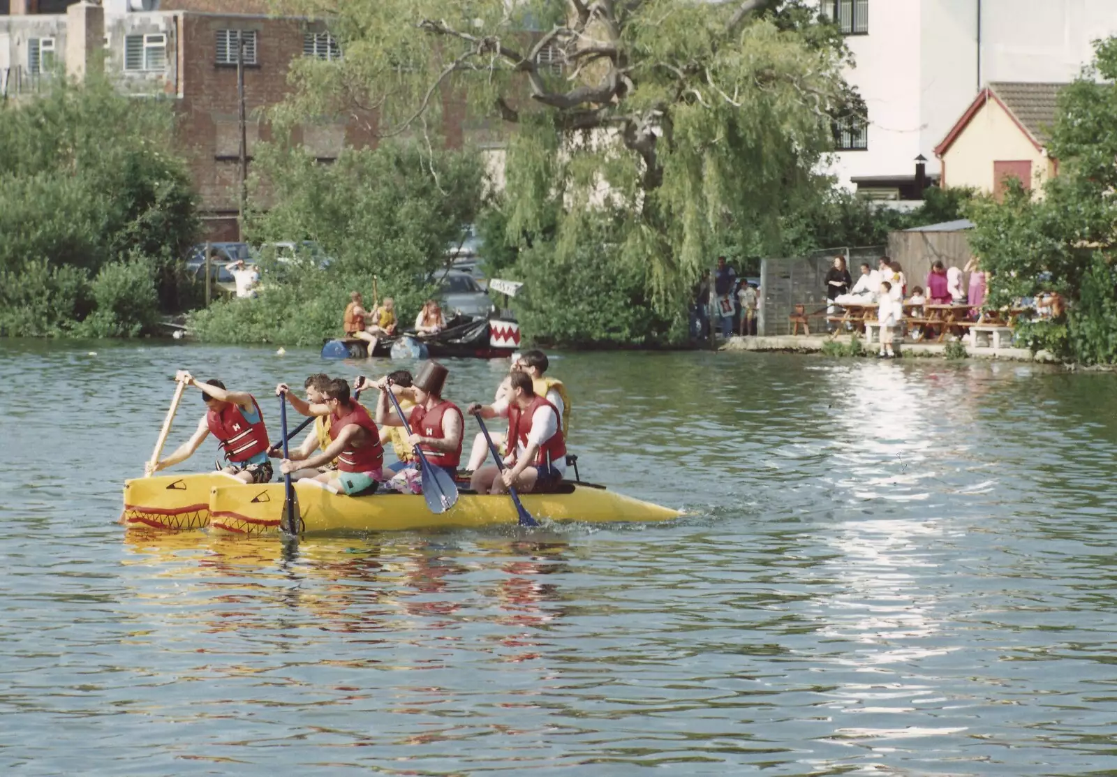 Frantic paddling on a yellow raft, from A Raft Race on the Mere, Diss, Norfolk - 2nd June 1990