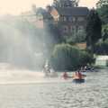 The rafts paddle through a wall of spray from firehoses, A Raft Race on the Mere, Diss, Norfolk - 2nd June 1990