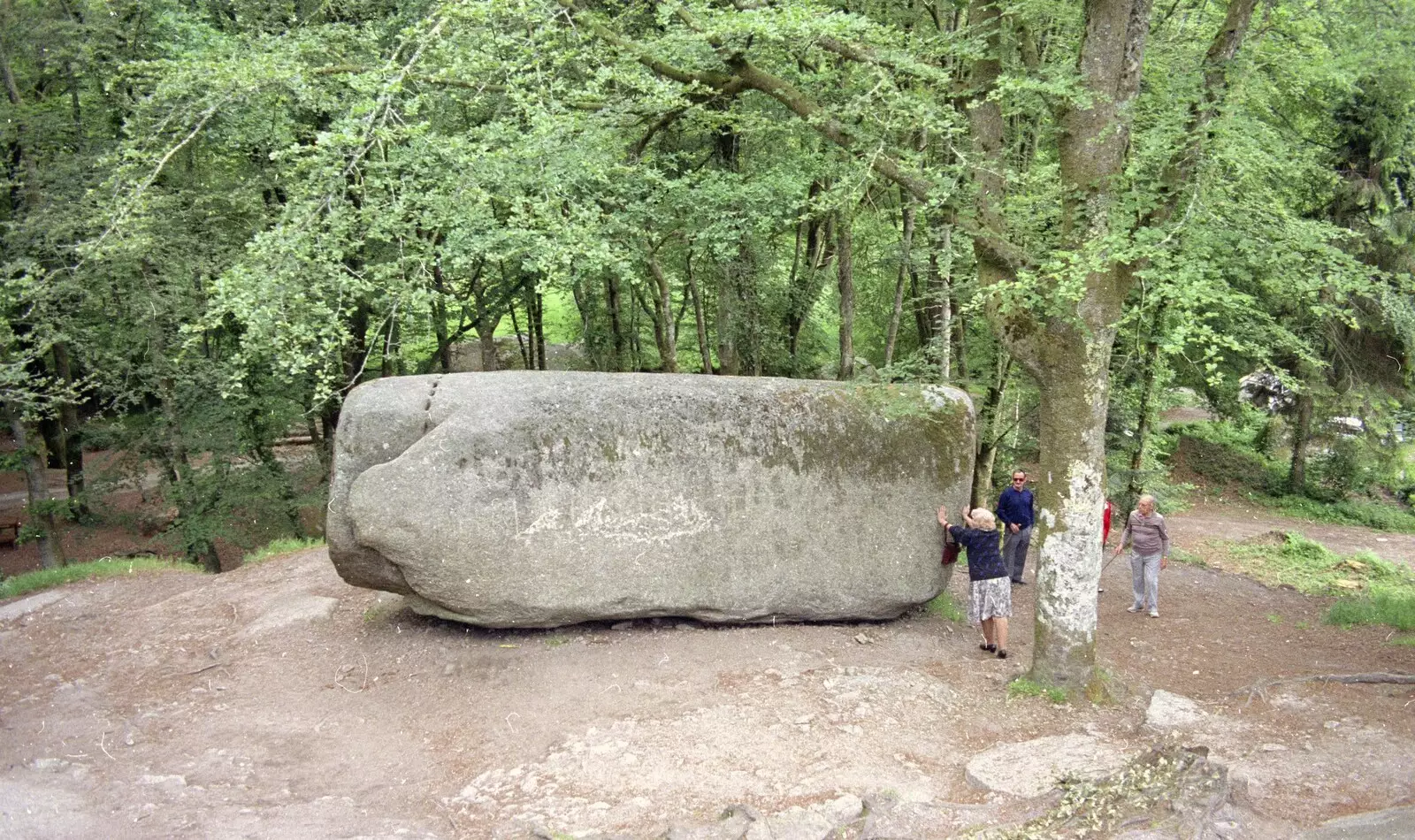 A woman has a go at the rock, from A Trip To Huelgoat, Brittany, France - 11th June 1990