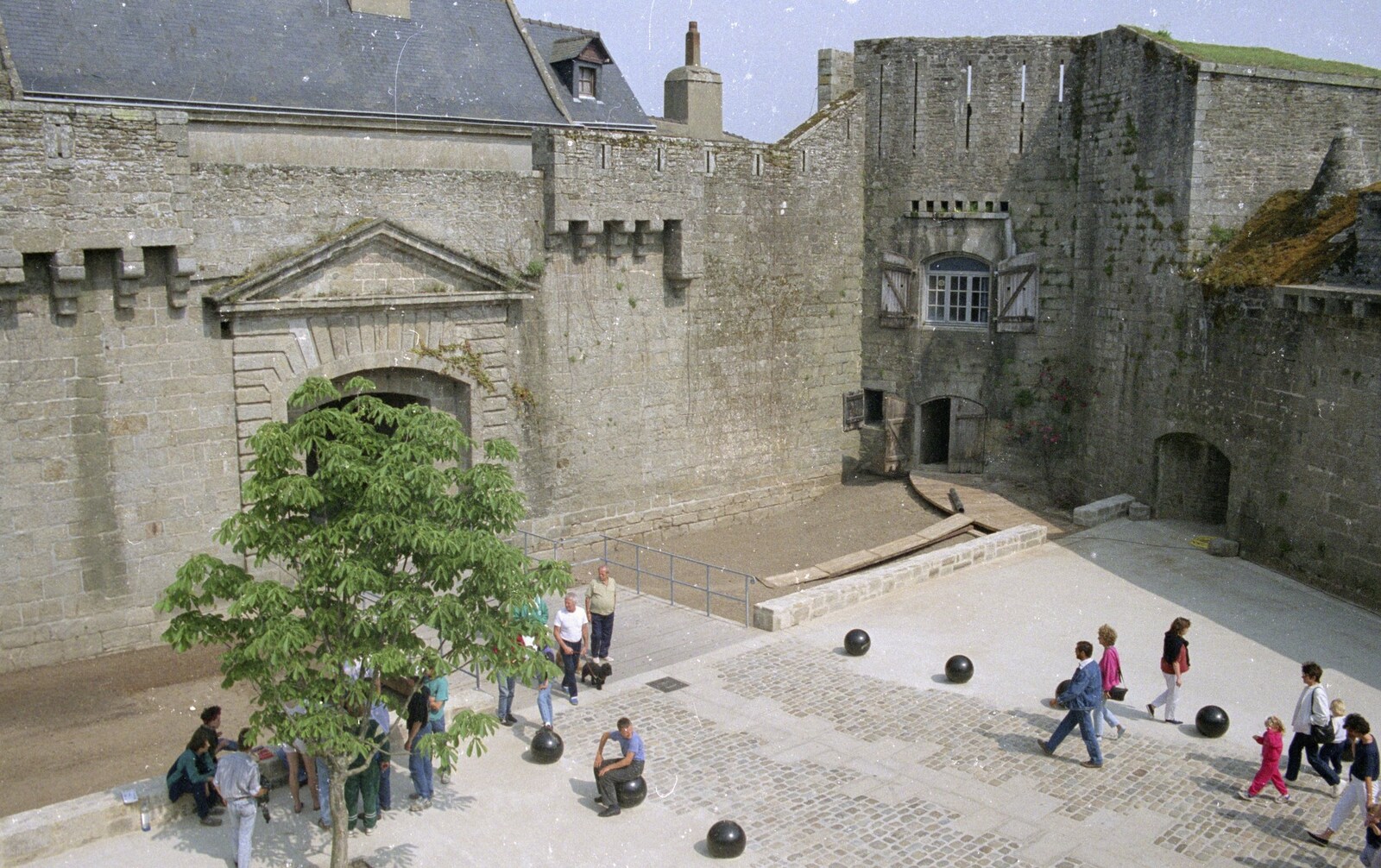 People mill around a square from A Trip To Huelgoat, Brittany, France - 11th June 1990