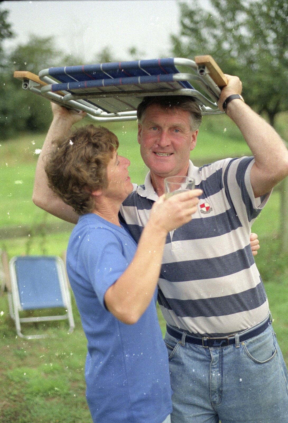 Sue's Fire Dance, Stuston, Suffolk - 21st July 1990: Bernie and Brenda take shelter under a camping chair