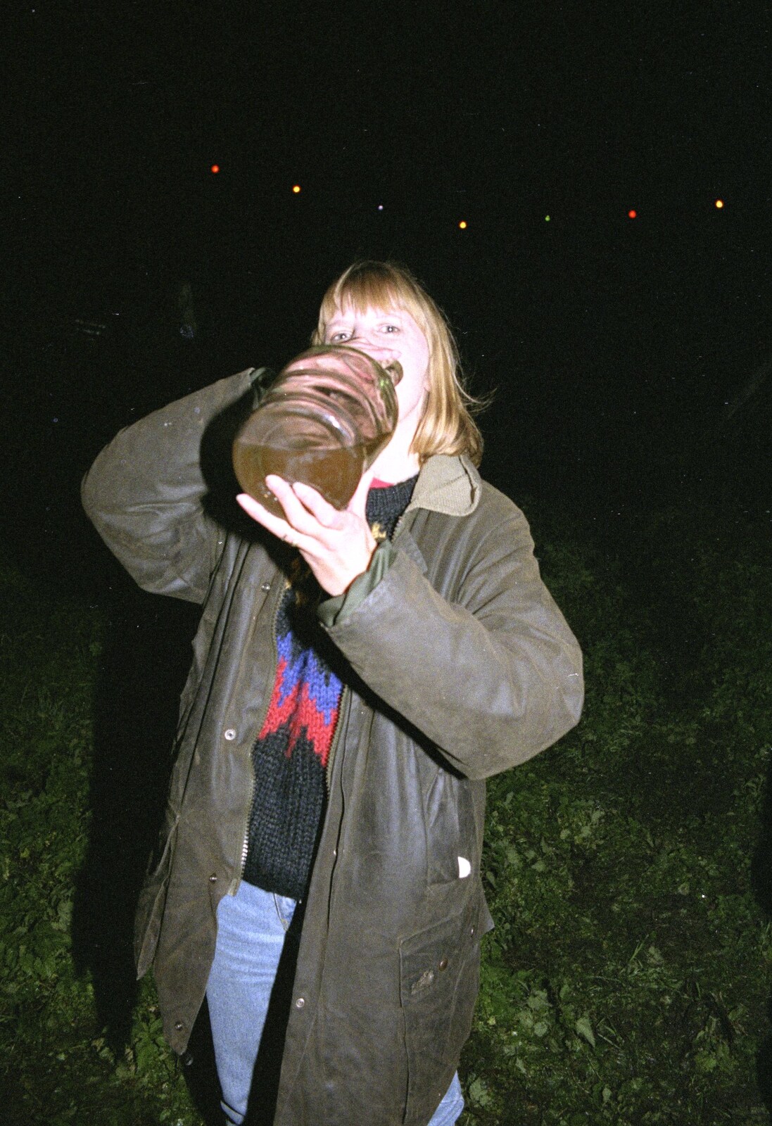 Janet has a swig from a demijohn of cider from Bonfire Night, Stuston, Suffolk - 5th November 1990
