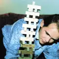 Phil by a toppling Jenga stack, New Year's Eve at Phil's, Hordle, Hampshire - 31st December 1990