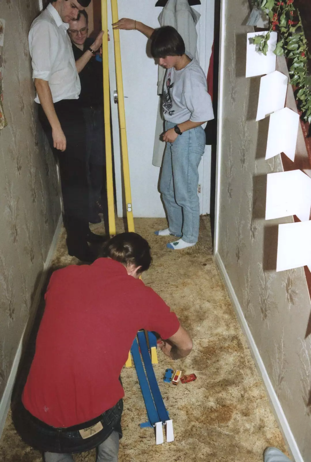 Phil sets up a Hot Wheels track, from New Year's Eve at Phil's, Hordle, Hampshire - 31st December 1990