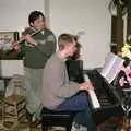 David plays flute to some piano accompaniment, Sledging on the Common and Some Music, Stuston, Suffolk - 5th February 1991