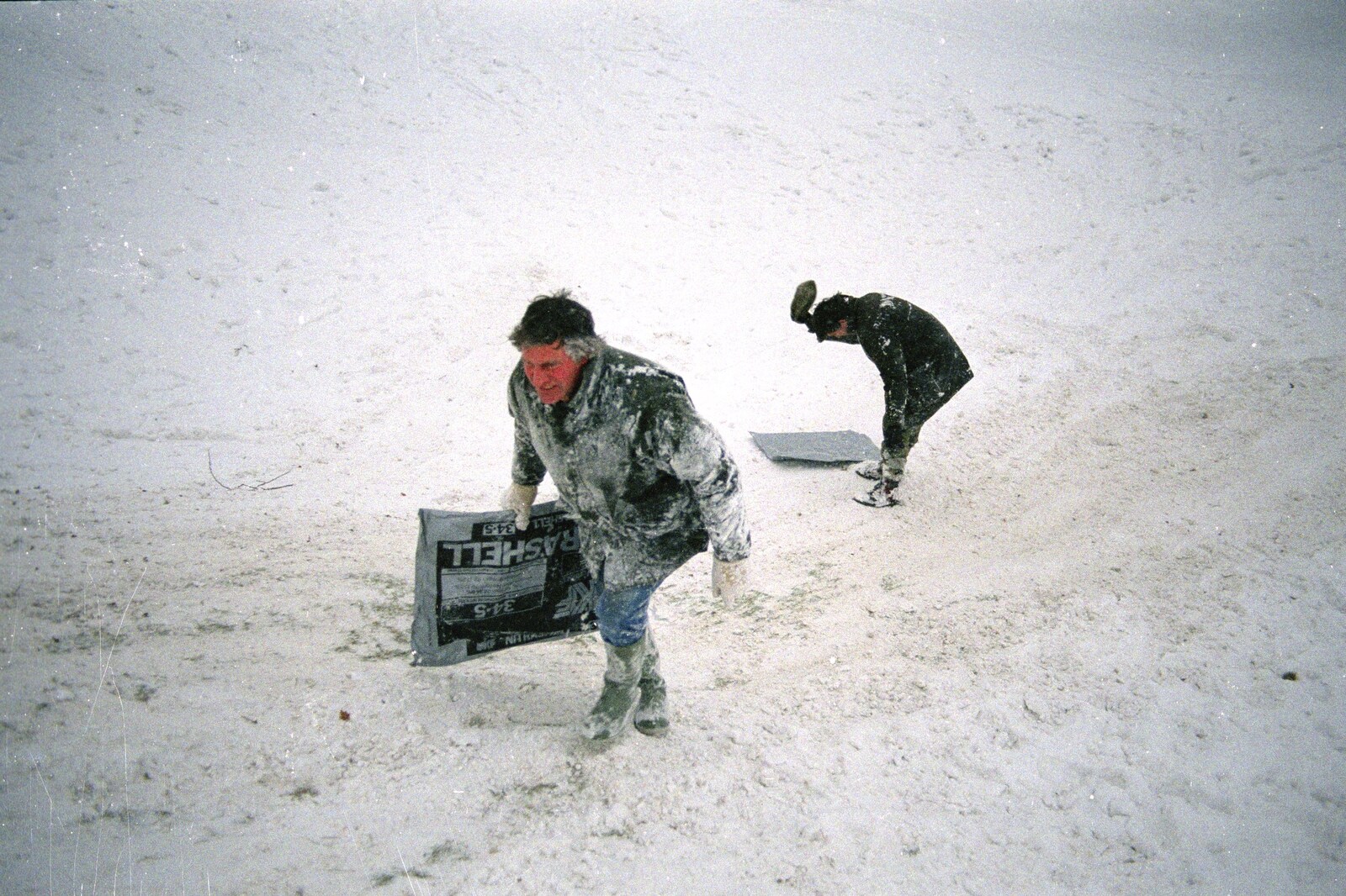 Geoff hauls his fertiliser bag up the hill from Sledging on the Common and Some Music, Stuston, Suffolk - 5th February 1991
