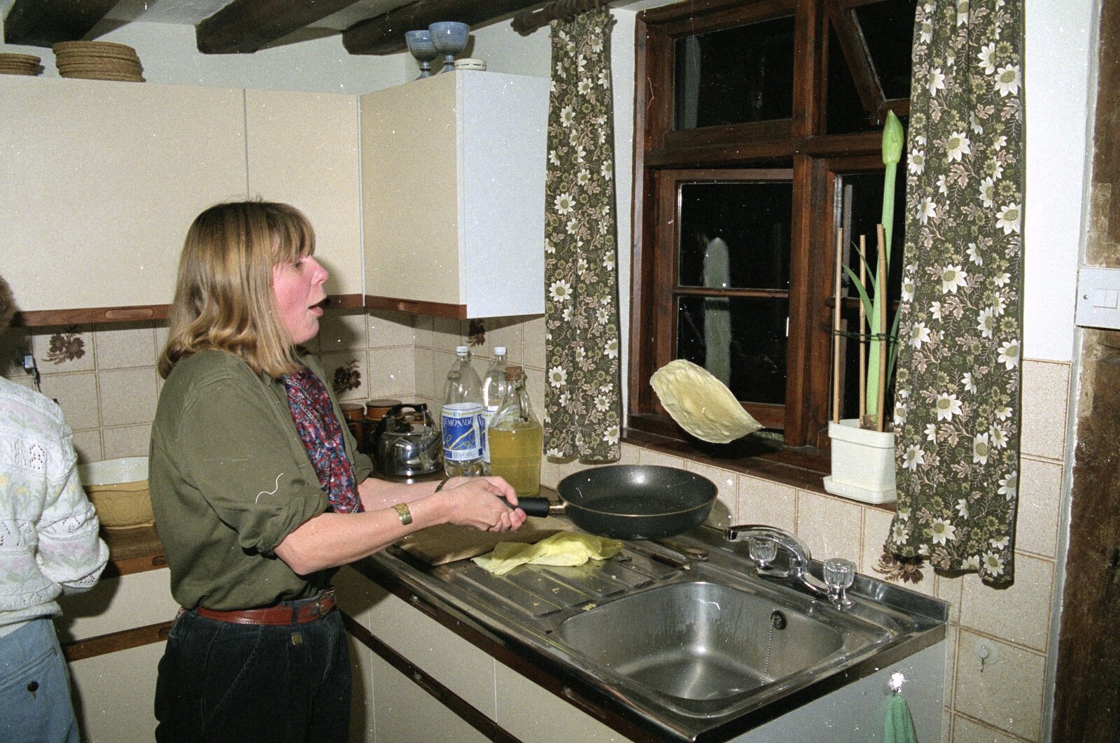 Janet flips her pancake from Pancake Day, Stuston, Suffolk - 18th February 1991