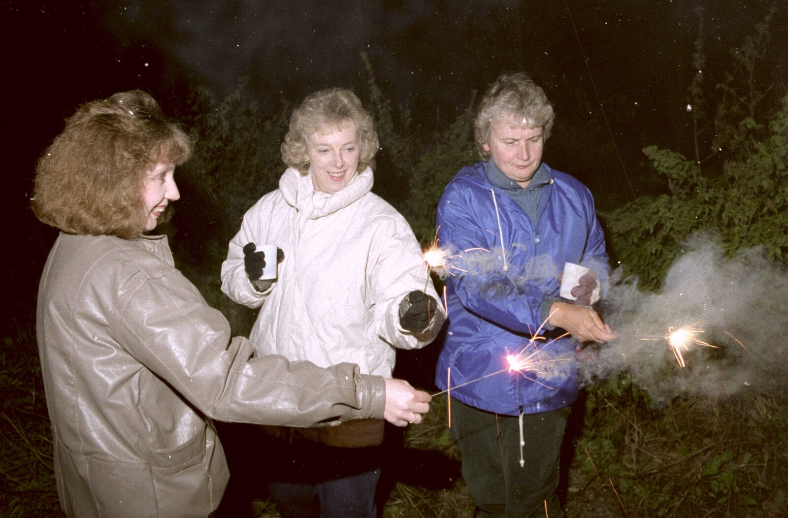 Monique, Jean and Linda do sparklers from Bonfire Night and Printec at the Stoke Ash White Horse, Suffolk - 5th November 1991