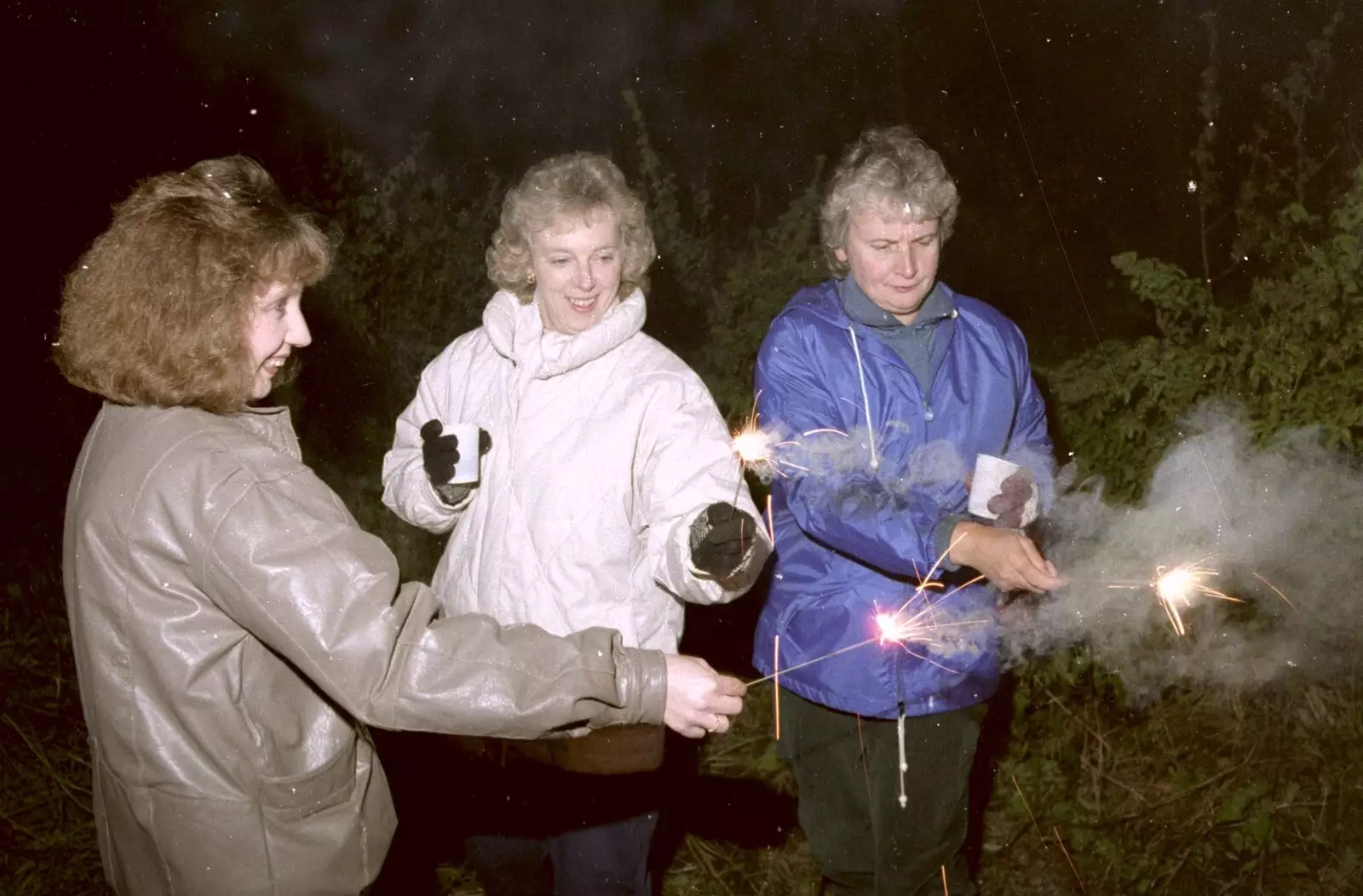 Monique, Jean and Linda do sparklers, from Bonfire Night and Printec at the Stoke Ash White Horse, Suffolk - 5th November 1991