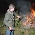 Geoff pokes the fire with a stick, Bonfire Night and Printec at the Stoke Ash White Horse, Suffolk - 5th November 1991