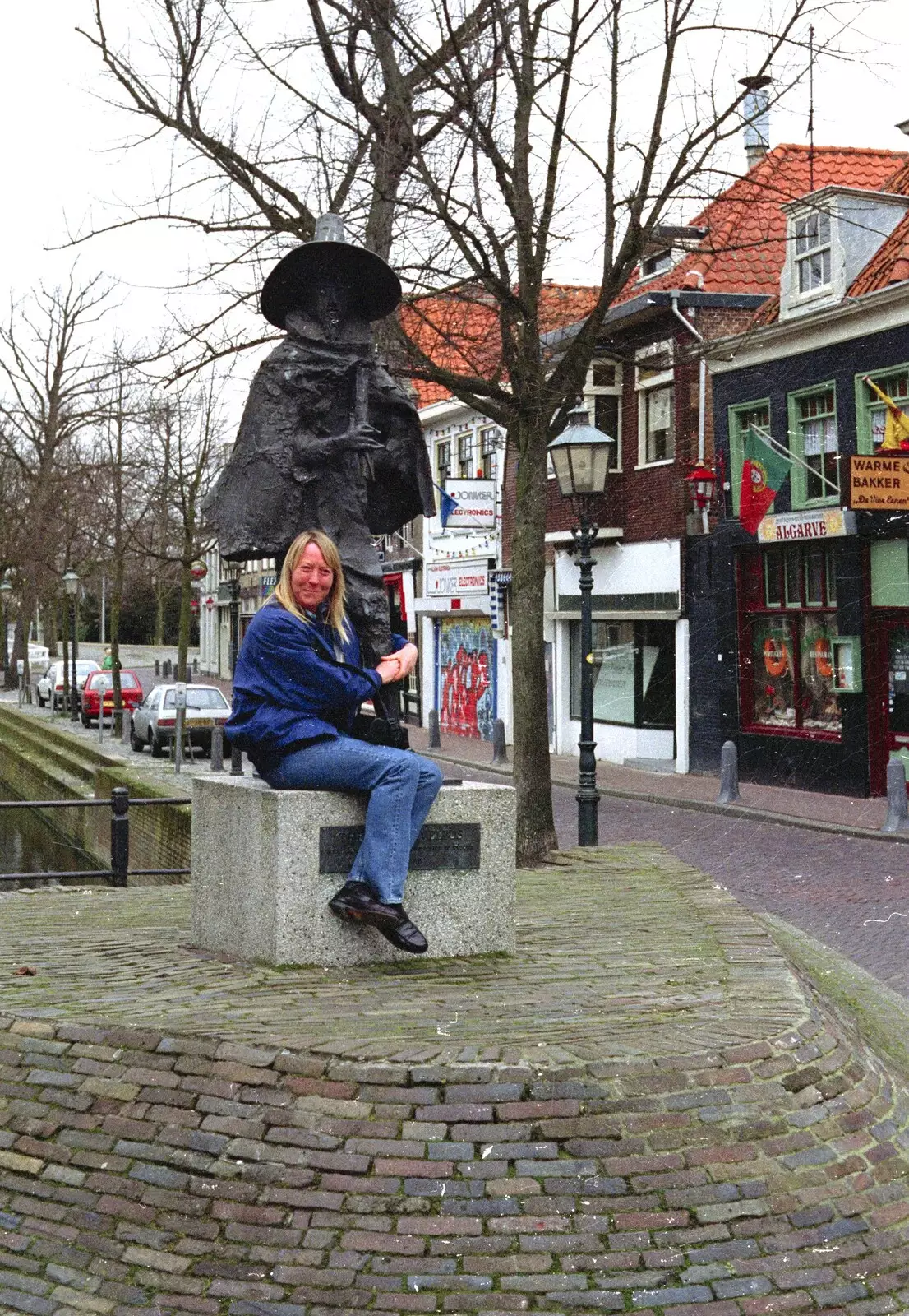 Sue hugs the legs of some statue, from Out and About in Amsterdam, Hoorne, Vollendam and Edam, The Netherlands - 26th March 1992