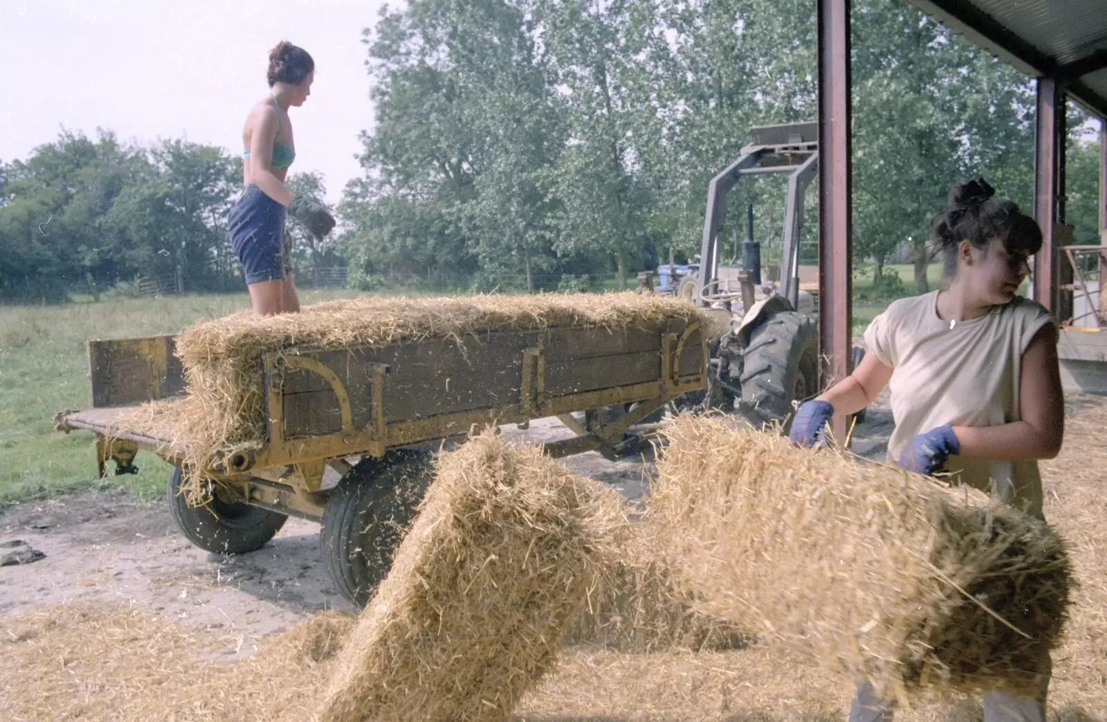 Rachel chucks bales around in the shed, from Working on the Harvest, Tibenham, Norfolk - 11th August 1992