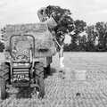 Nosher pitches a bale up to Sarah, Working on the Harvest, Tibenham, Norfolk - 11th August 1992