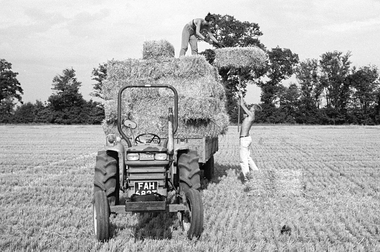 Nosher lifts a bale on a pitchfork from Working on the Harvest, Tibenham, Norfolk - 11th August 1992
