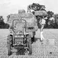 Nosher lifts a bale on a pitchfork, Working on the Harvest, Tibenham, Norfolk - 11th August 1992