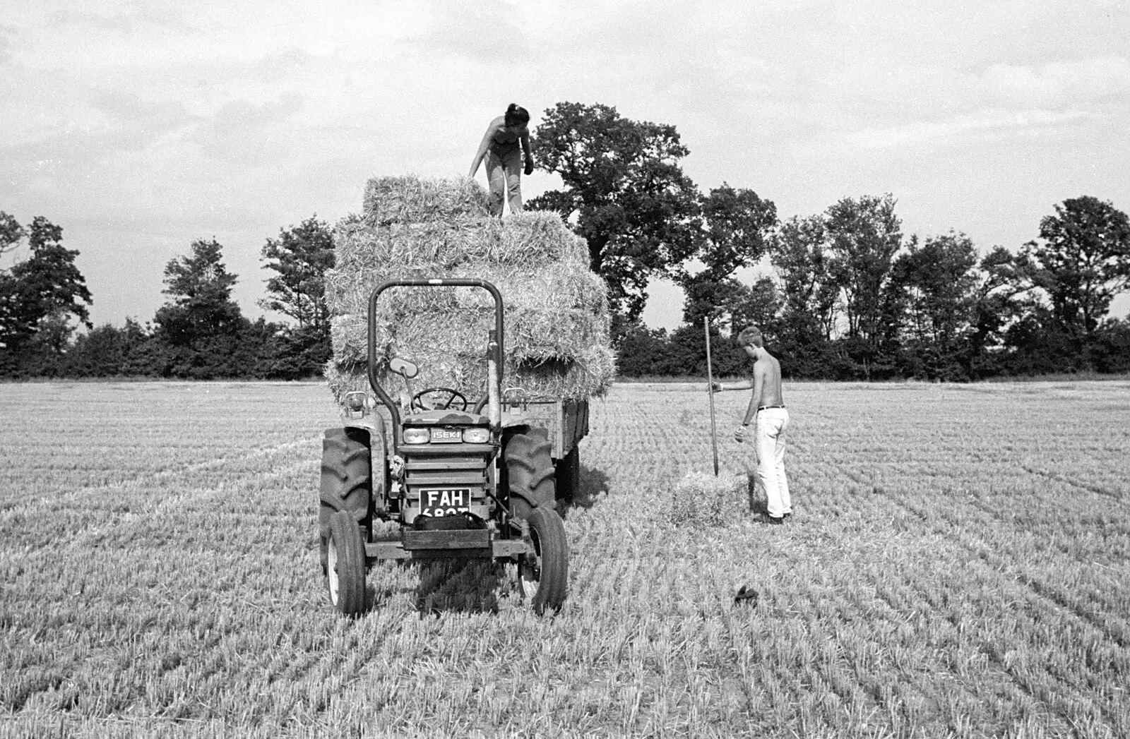 Considering the next bale, from Working on the Harvest, Tibenham, Norfolk - 11th August 1992