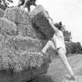 Rachel half-climbs up to shift a bale, Working on the Harvest, Tibenham, Norfolk - 11th August 1992