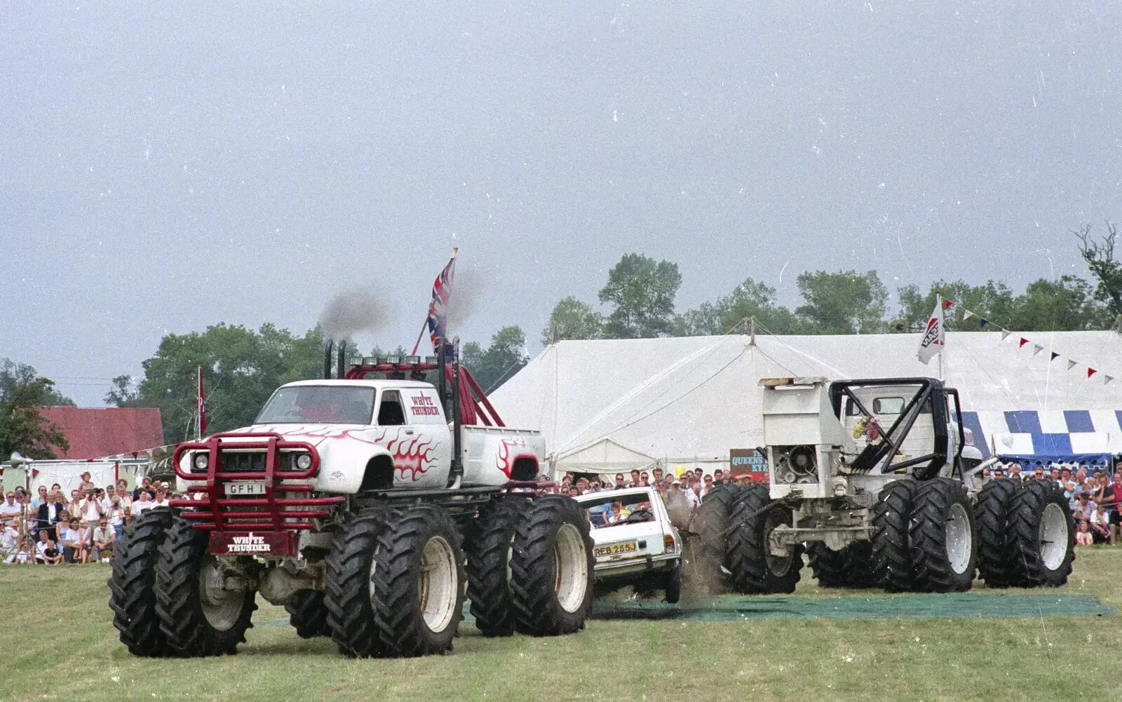 A couple of 'monster trucks' eat an old Fiesta, from The Eye Show and a Trip to Halifax, Suffolk and South Yorkshire - 28th August 1992