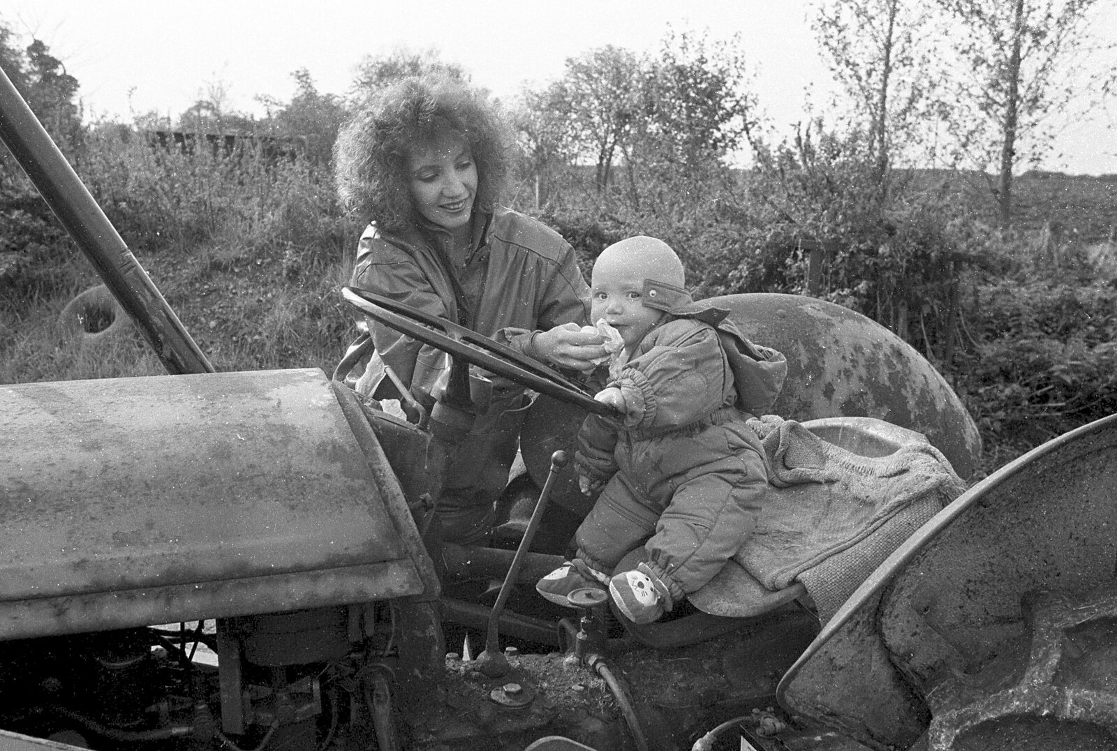 Monique wipes something off the baby's face from Cider Making in Black and White, Stuston, Suffolk - 11th October 1992