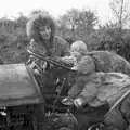 Monique wipes something off the baby's face, Cider Making in Black and White, Stuston, Suffolk - 11th October 1992