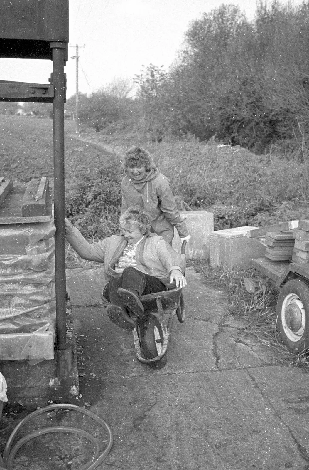 Linda gets wheeled about in a barrow, from Cider Making in Black and White, Stuston, Suffolk - 11th October 1992