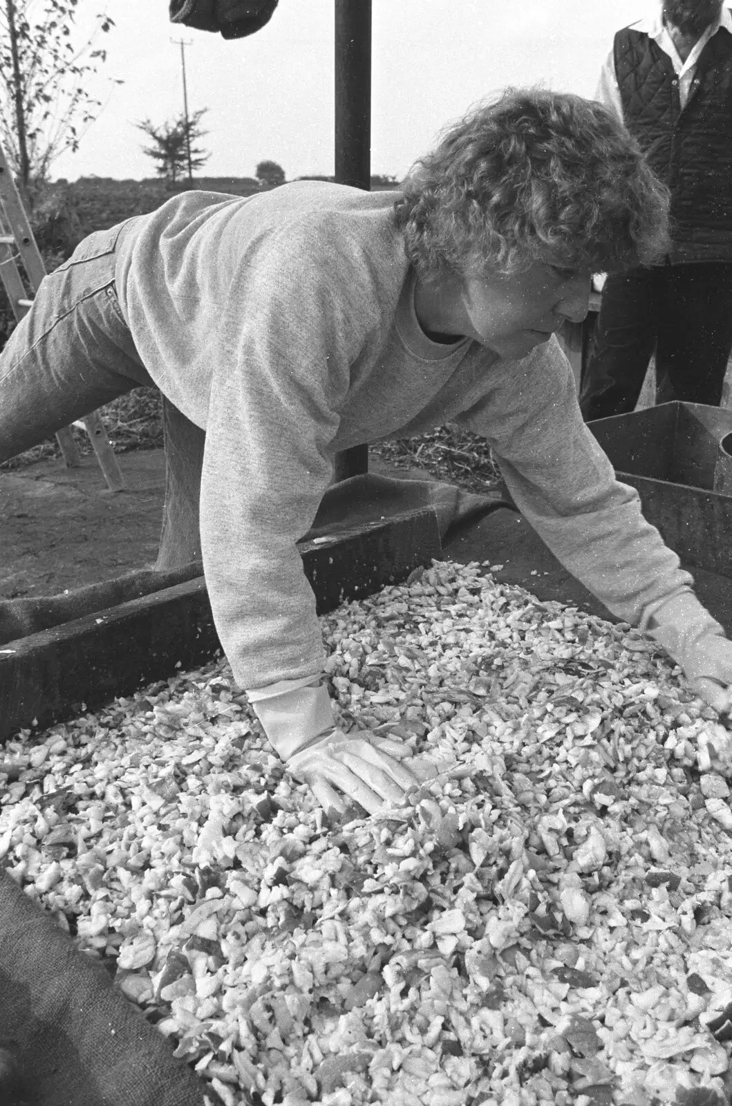 Brenda spreads chopped apple around, from Cider Making in Black and White, Stuston, Suffolk - 11th October 1992