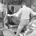 Geoff lays down another layer of muslin, Cider Making in Black and White, Stuston, Suffolk - 11th October 1992